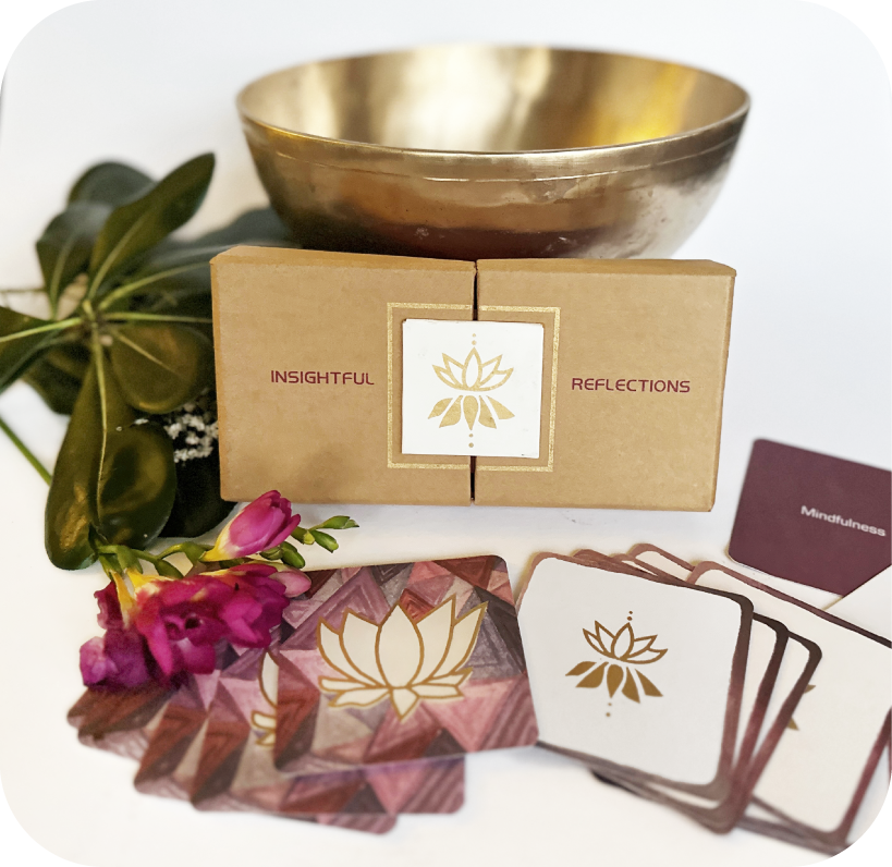 Insightful Reflections box opened to display contents. Several cards are laid out showing their decorative tops. Two cards in the center are flipped up, reading 'What gift can I give myself today?' and the other says 'Mindfulness'.