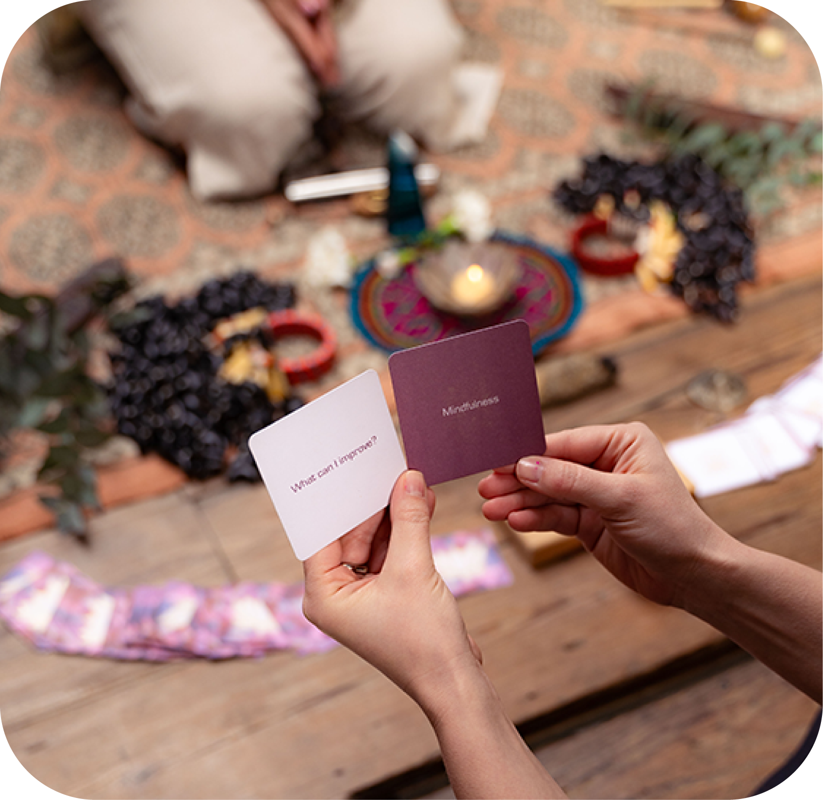 Woman fanning mindfulness cards with Tibetan singing bowls in the background.